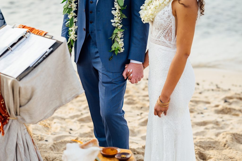 bride and groom holding hands during their elopement in Hawaii