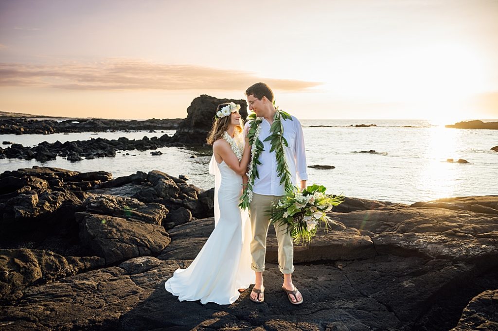 Couple on black rocks during their elopement in Hawaii