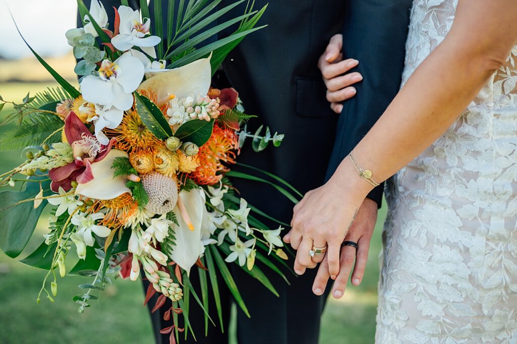 wedding flowers and enter twined hands