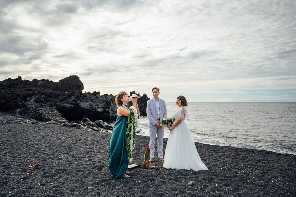 wedding officiant blowing conch shell during wedding