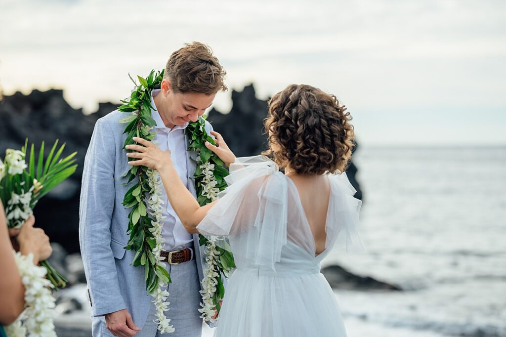 bride putting lei on her spouse