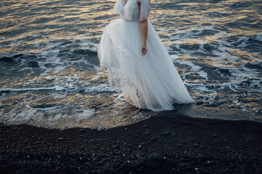 wedding dress on a black sand beach