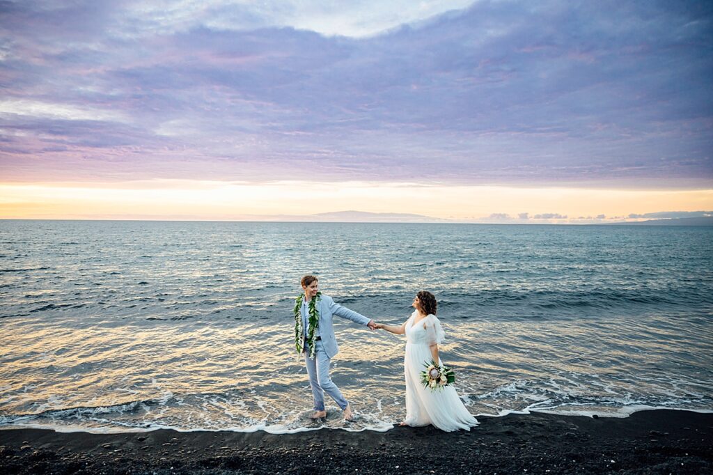 newlyweds at sunset on a black sand beach